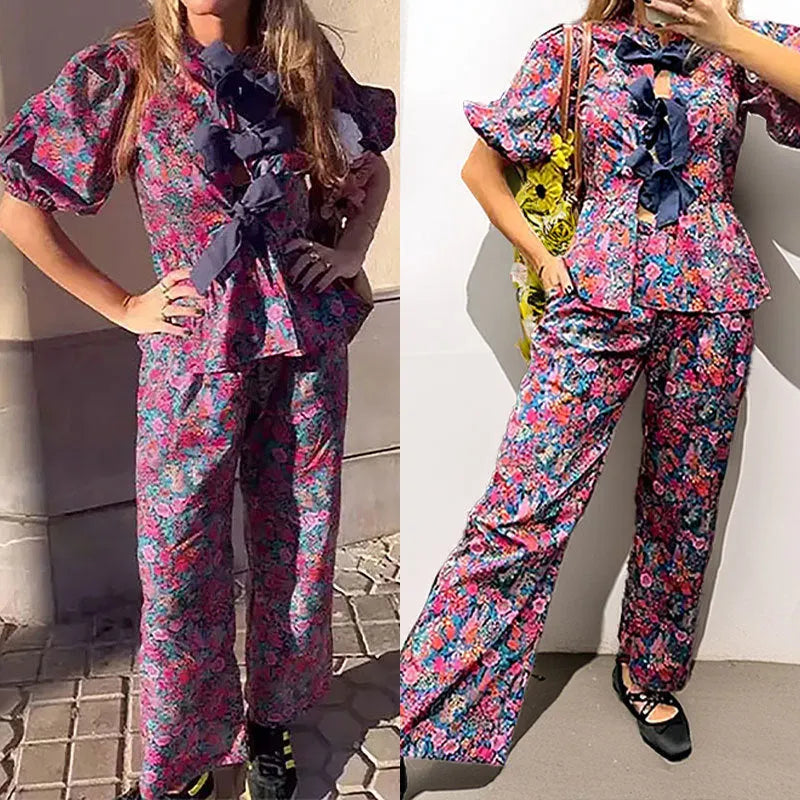Women's floral print trousers suit with a tie-neck puff sleeve top and matching trousers