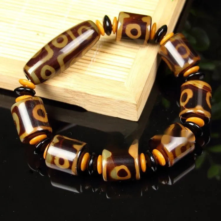 Distressed agate Tibet beads bracelet with three eye dzi design and polished stone beads