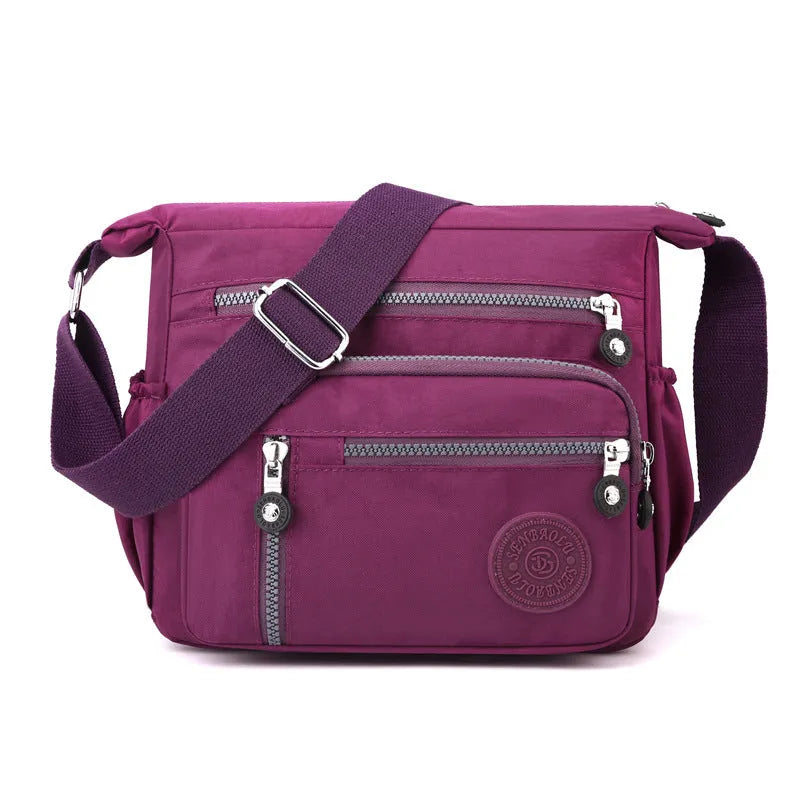 Grey square vertical nylon messenger bag with a single shoulder strap shown open.