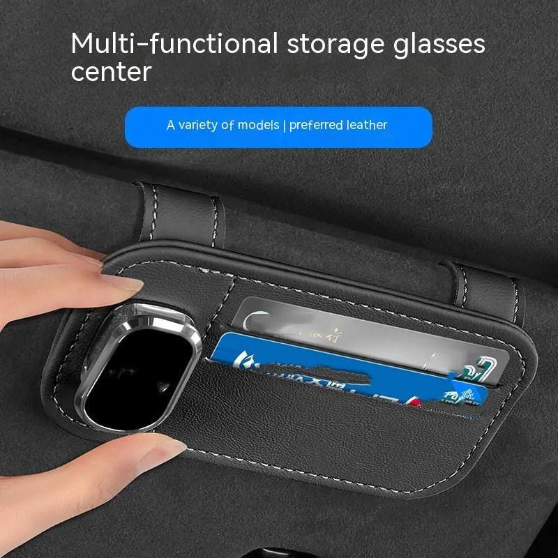 Cowhide car sun visor holder with card slots and a sunglasses clip attached to a grey visor.