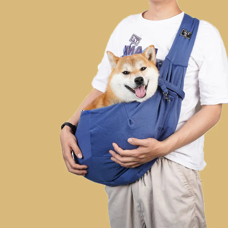 Large grey folding cat messenger backpack with mesh windows, shown on a person's back.