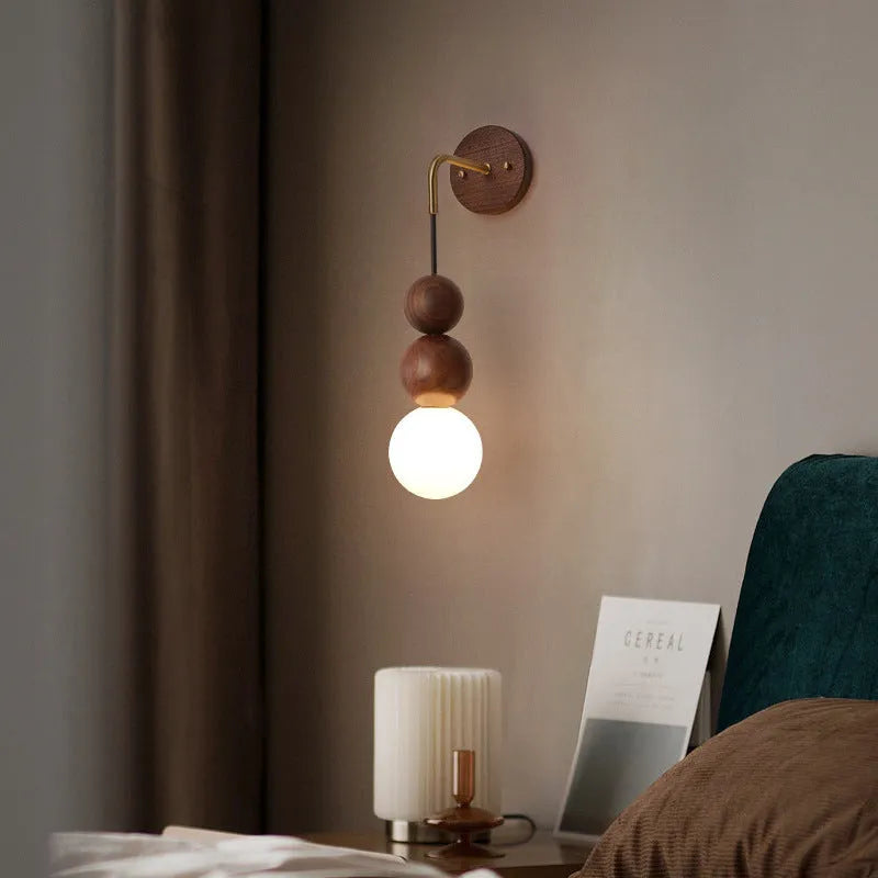 Wood and copper cylindrical wall lamp with suspension wire, showing Walnut and copper colour variants.