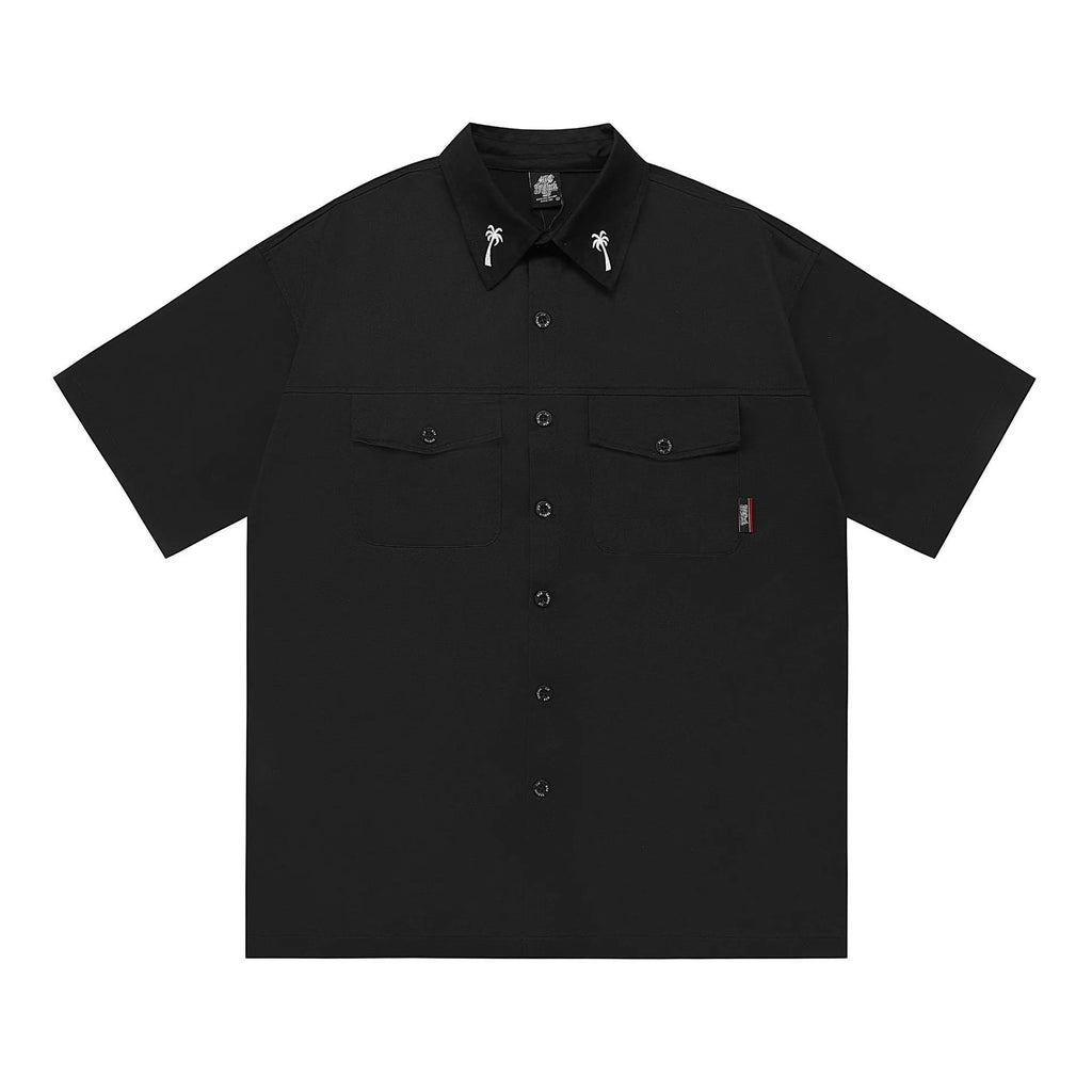 Man wearing a black loose-fit cotton blend embroidered pocket shirt with half-length sleeves.