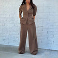 Brown men's slim fit polyester suit with long sleeves on a hanger