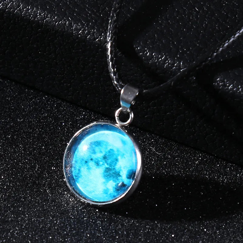 Luminous alloy necklace with a glass pendant depicting a Christmas moon night sky, showing the extension chain.