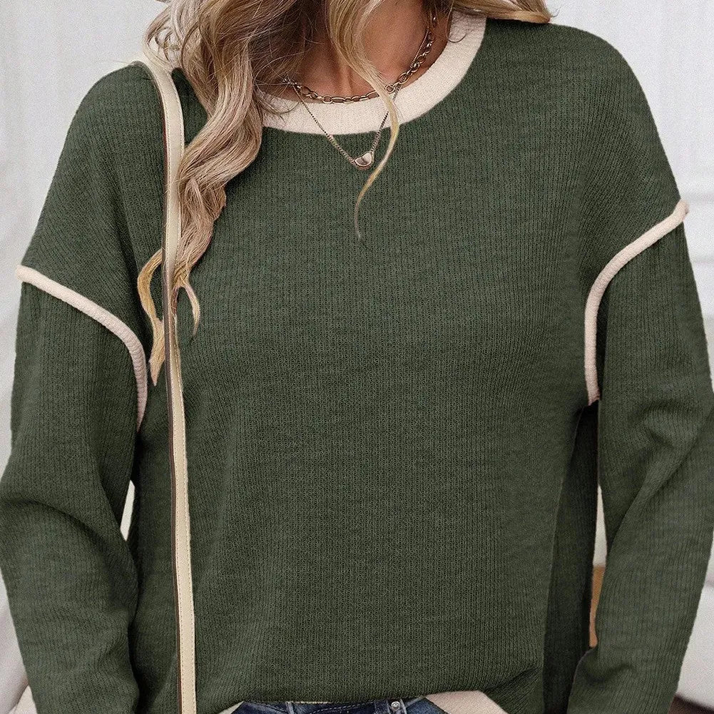 Drop shoulder loose knit top with four leaf clover contrast trim on the front, shown in beige.