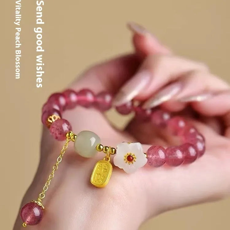 Handcrafted strawberry quartz crystal bracelet with Hetian jade peach blossom charms