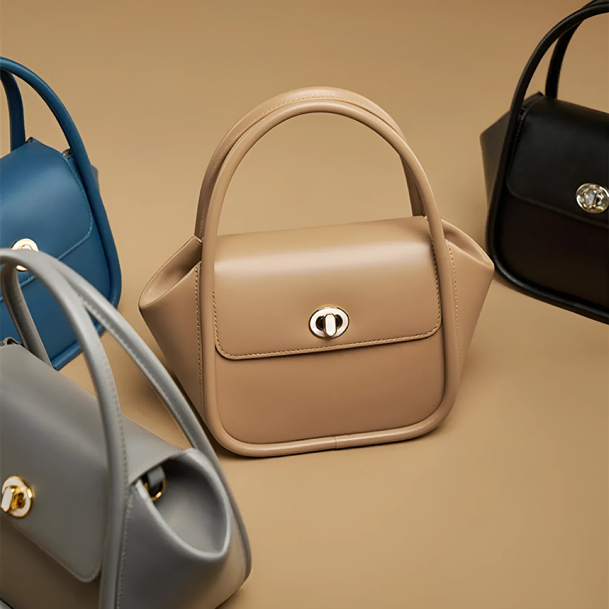 A women's cow leather wing-shaped handbag with a latch closure and a single shoulder strap.