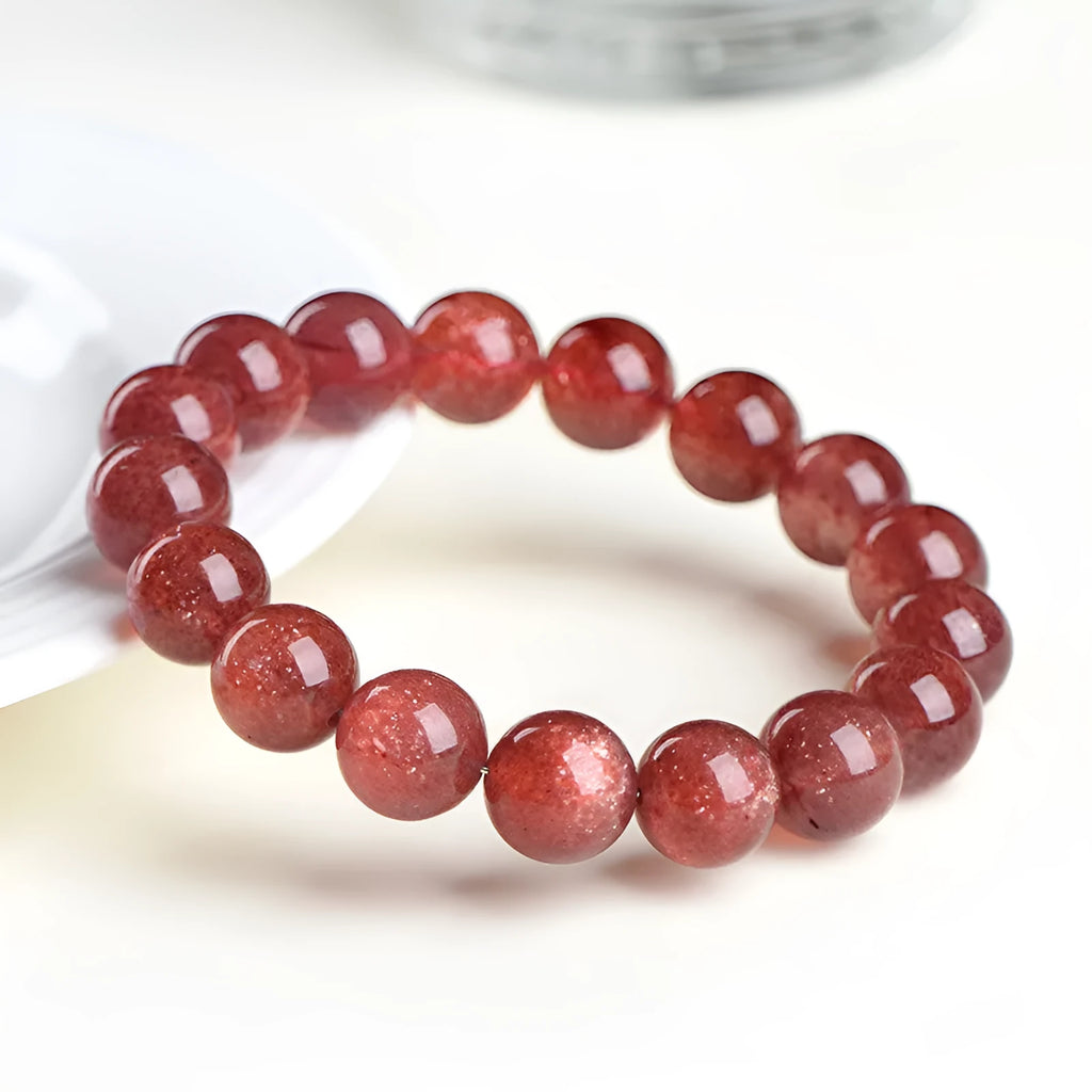 Natural strawberry quartz bracelet showing cherry red colour with starlight effects on geometric beads