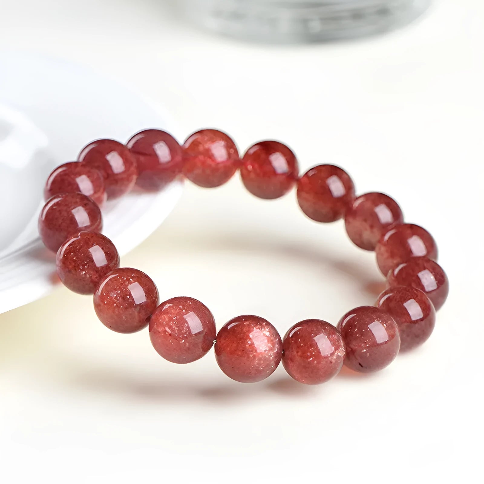 Natural strawberry quartz bracelet showing cherry red colour with starlight effects on geometric beads