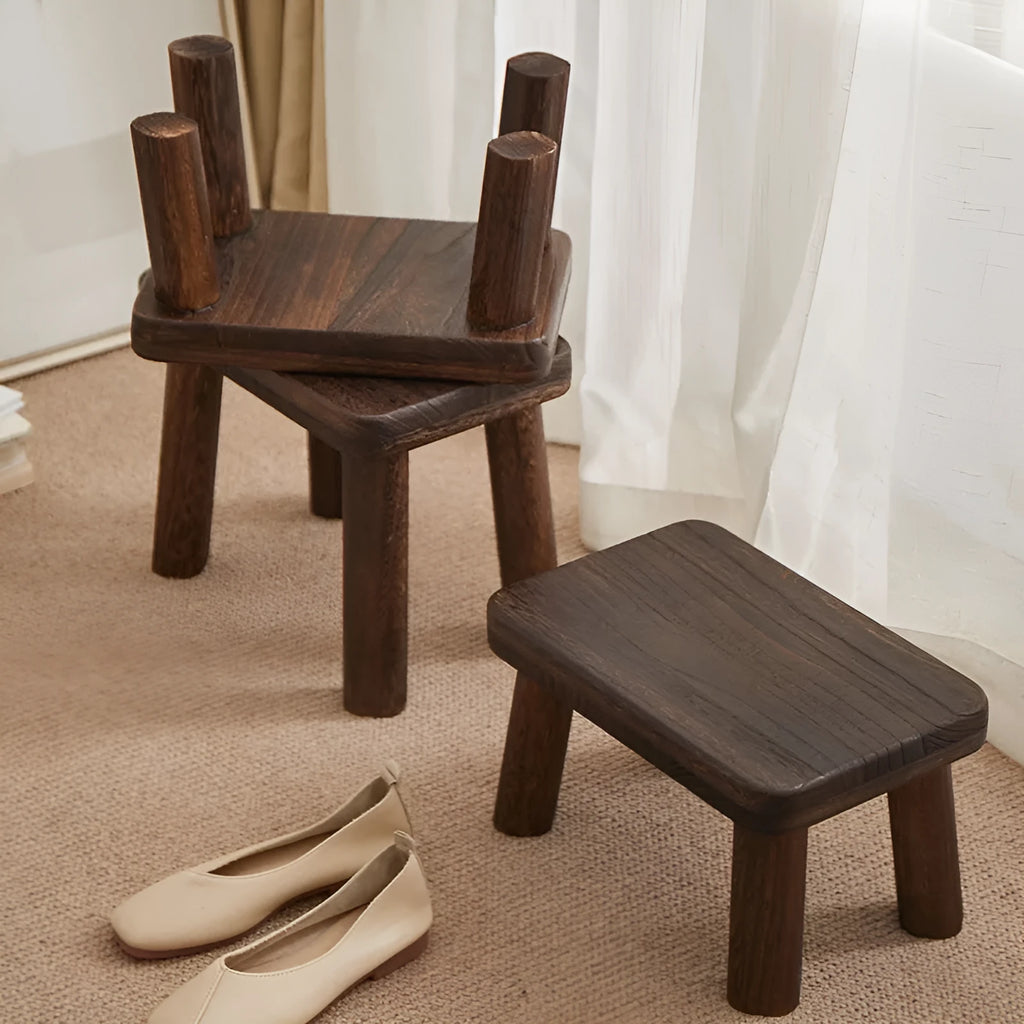 Solid wood distressed finish changing stool with bracket structure legs.