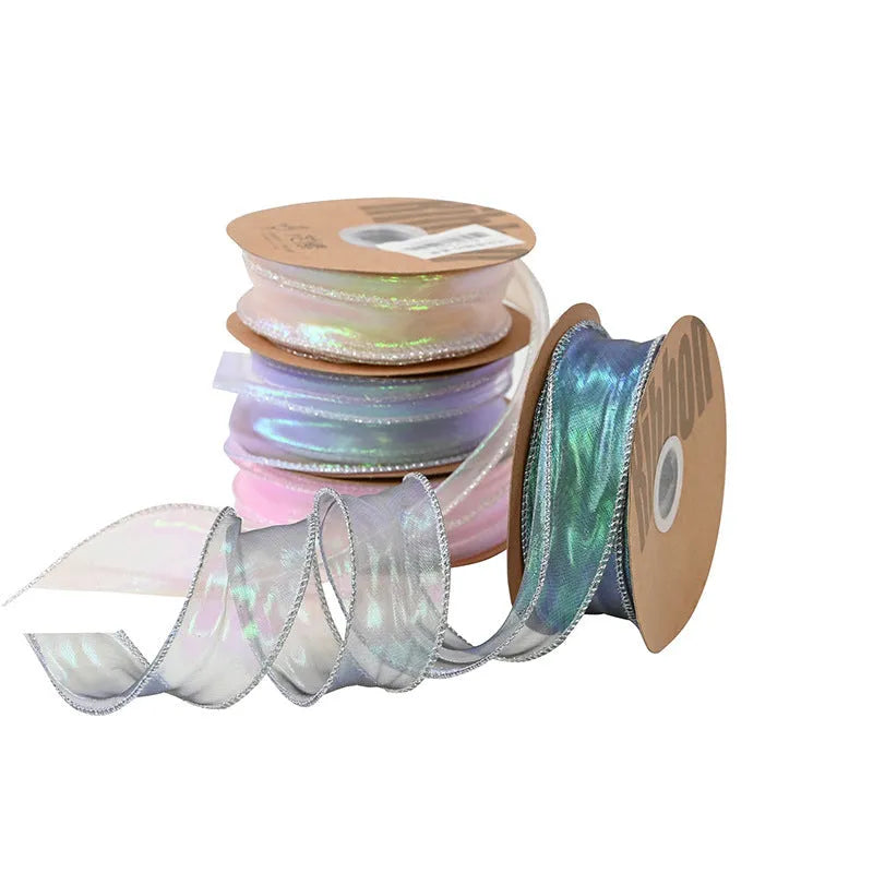 Roll of 4cm wide mesh fishtail yarn ribbon in colourful wave design for craft projects.