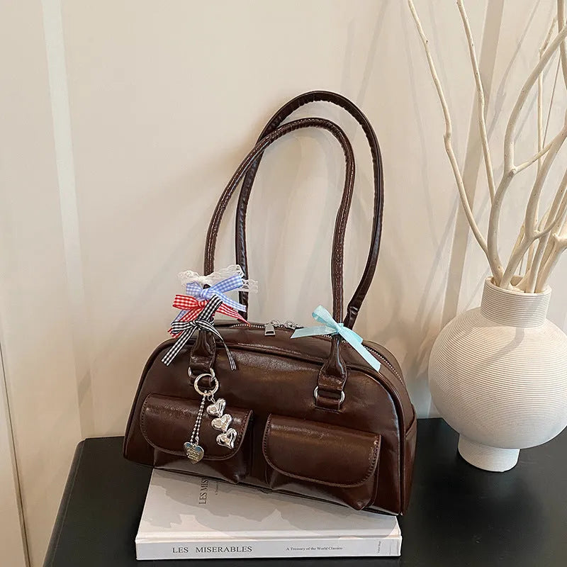 Retro brown PU leather pillow-shaped women's shoulder bag with double straps and a flap closure.