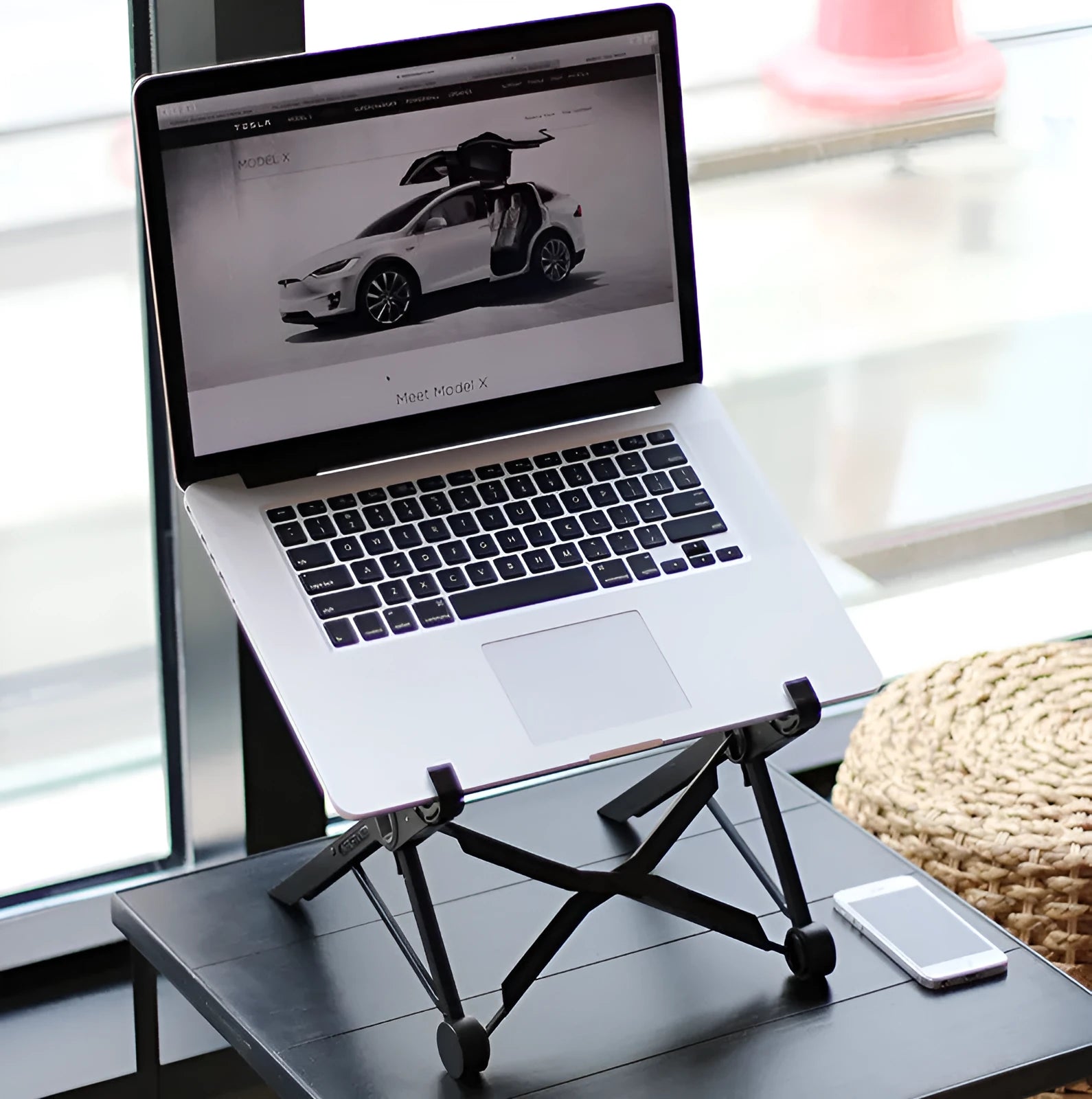Black reinforced nylon folding laptop stand shown in a folded position with dimensions.