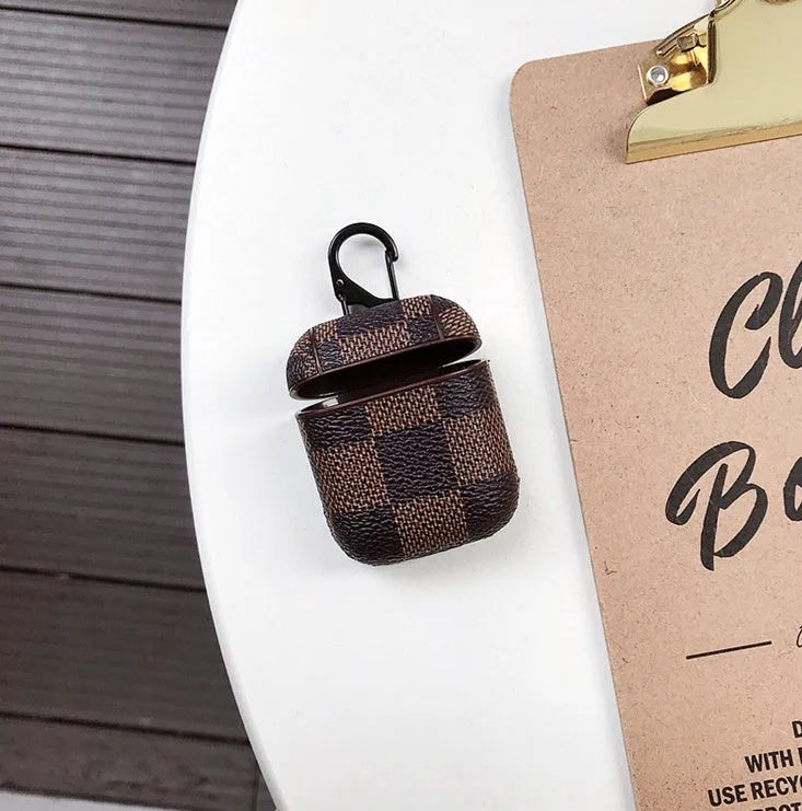 Hard plastic iPhone XS Max case with a hook for a Bluetooth headset, shown in a grid pattern design.
