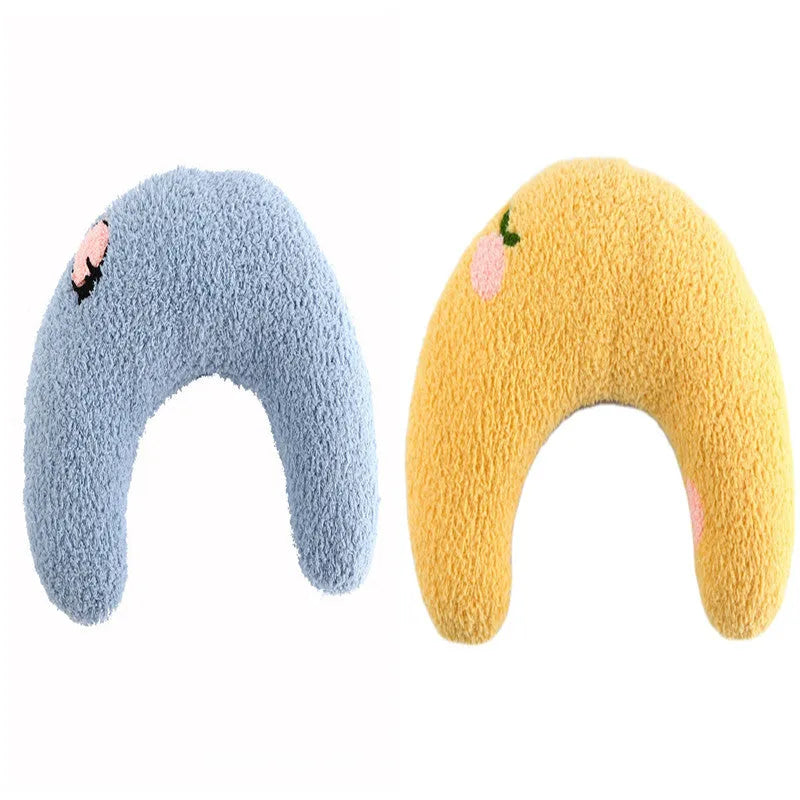 White U-shaped plush pet pillow for a cat, showing its donut shape and quilted texture.