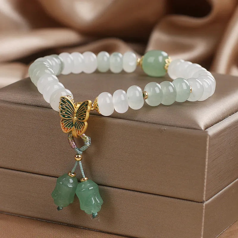 Green crystal women's bracelet with abacus beads and butterfly tassel decoration