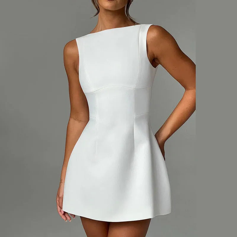 Black backless sling dress with slim fit and short skirt on a model.