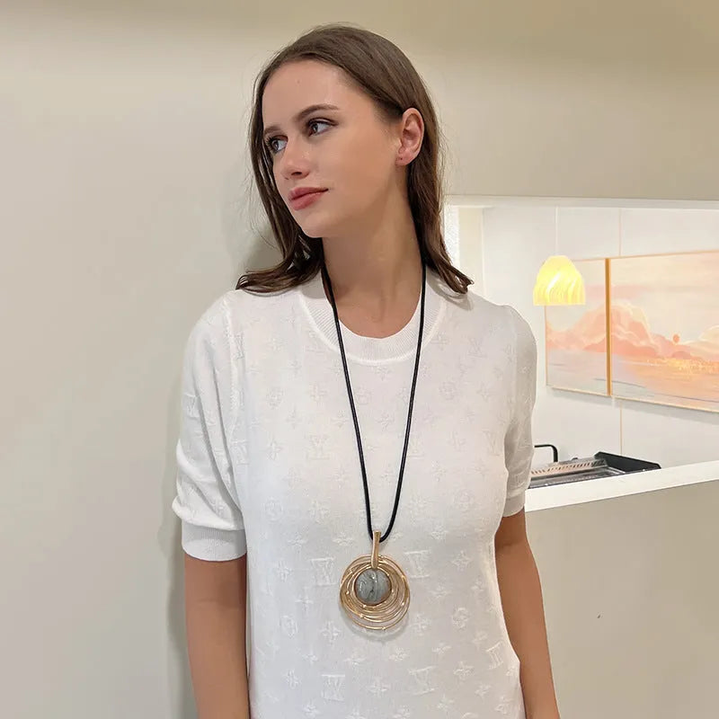 Gold geometric sweater chain necklace with adjustable snakeskin rope chain and large round pendant