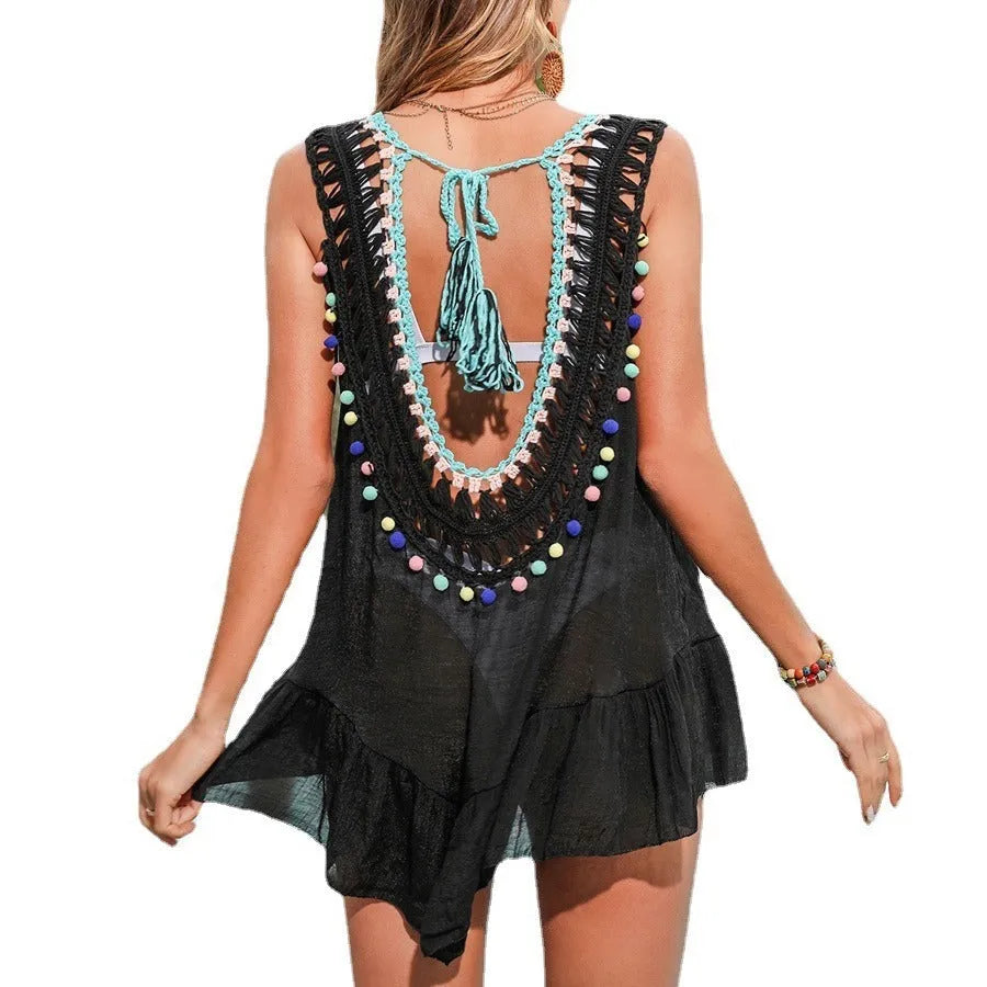 Black crochet women's beach cover-up with cut-out ruffles and a polyester lining.
