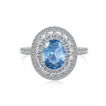 Women's S925 sterling silver ring with sea blue zircon heart or bow shape on plain background