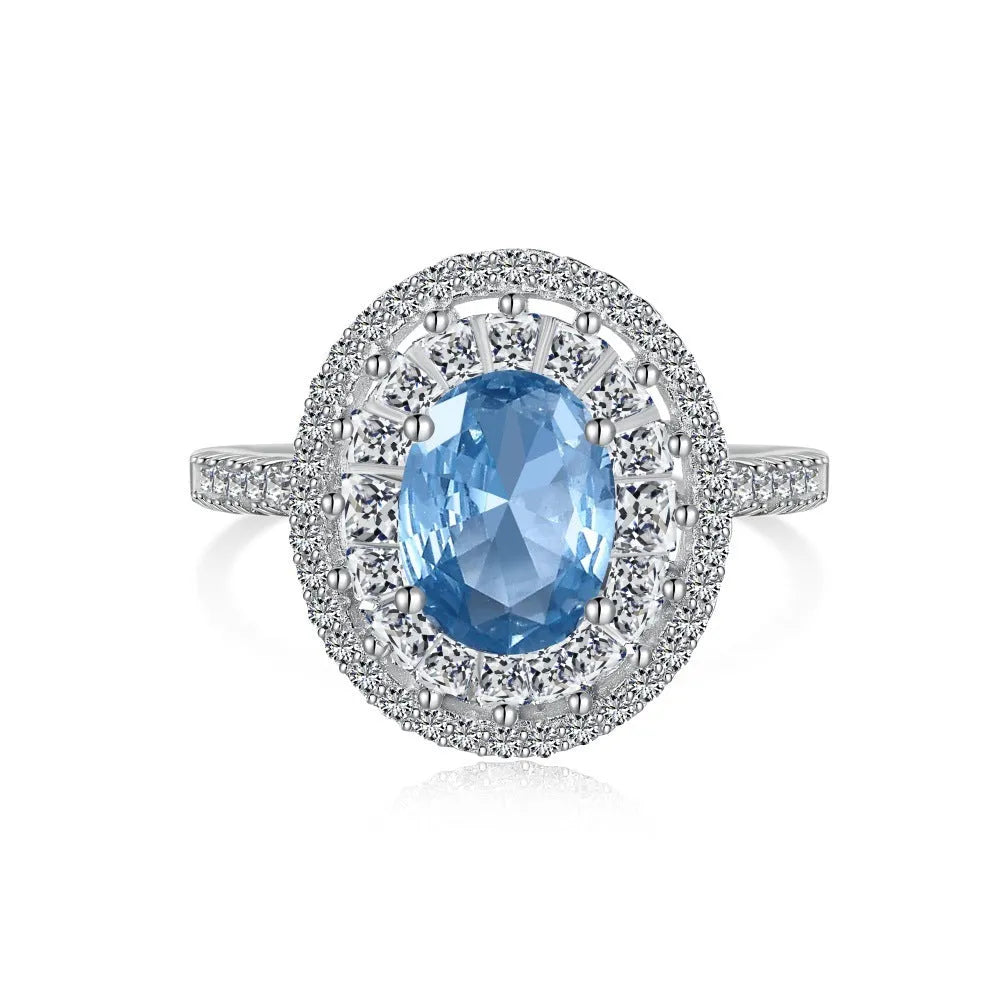 Women's S925 sterling silver ring with sea blue zircon heart or bow shape on plain background