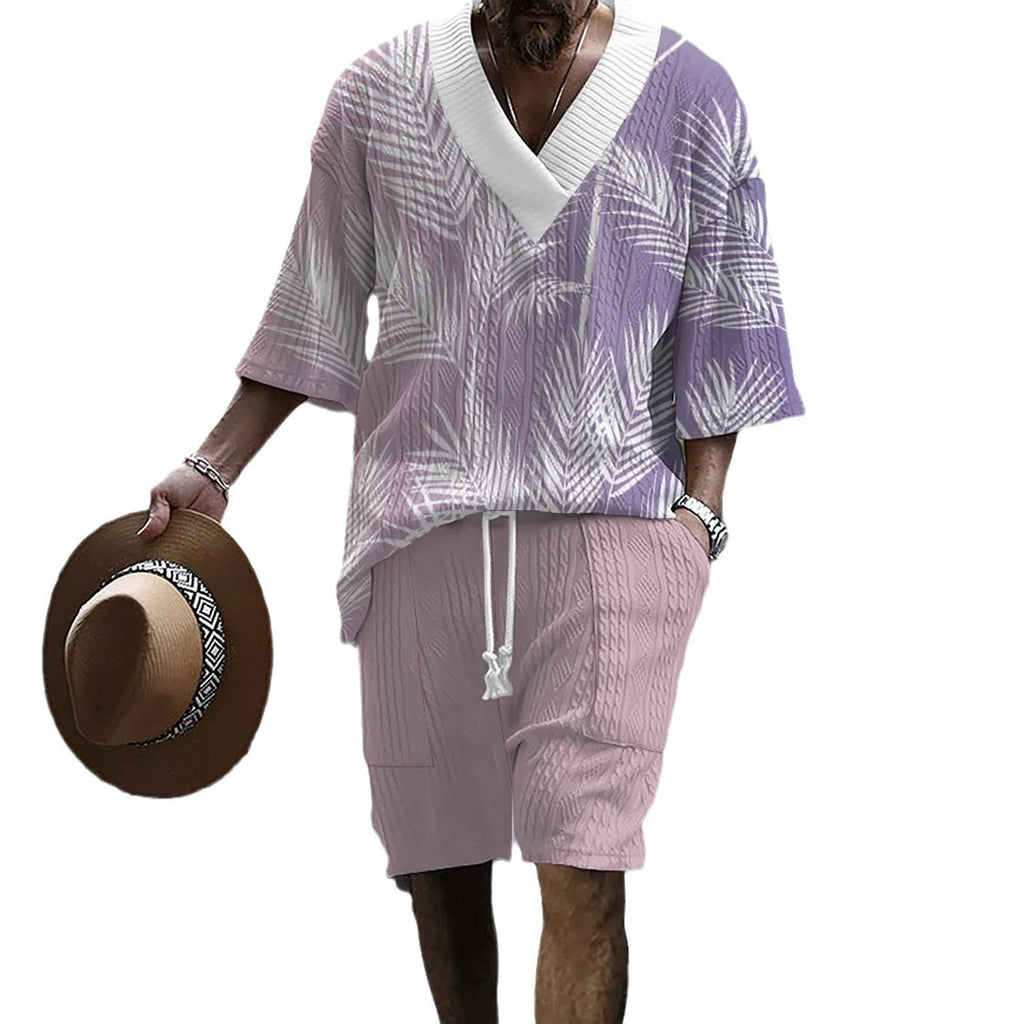 Man wearing a printed drop-shoulder knitted short-sleeved top with matching shorts in a solid colour.
