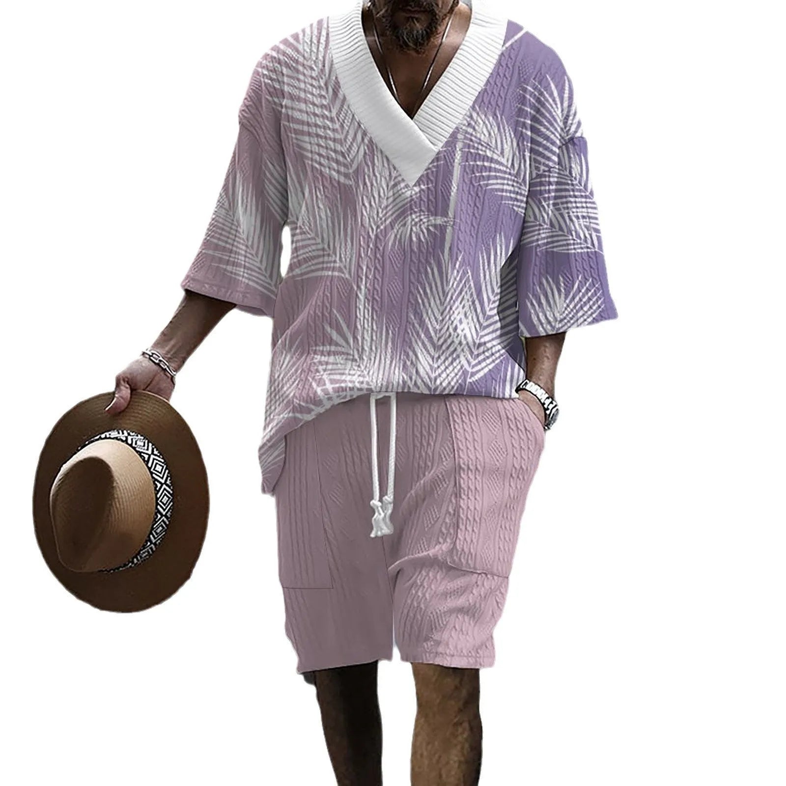 Man wearing a printed drop-shoulder knitted short-sleeved top with matching shorts in a solid colour.