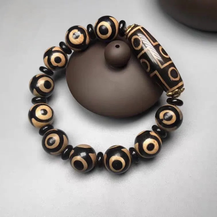 Distressed agate Tibet beads bracelet with three eye dzi design and polished stone beads