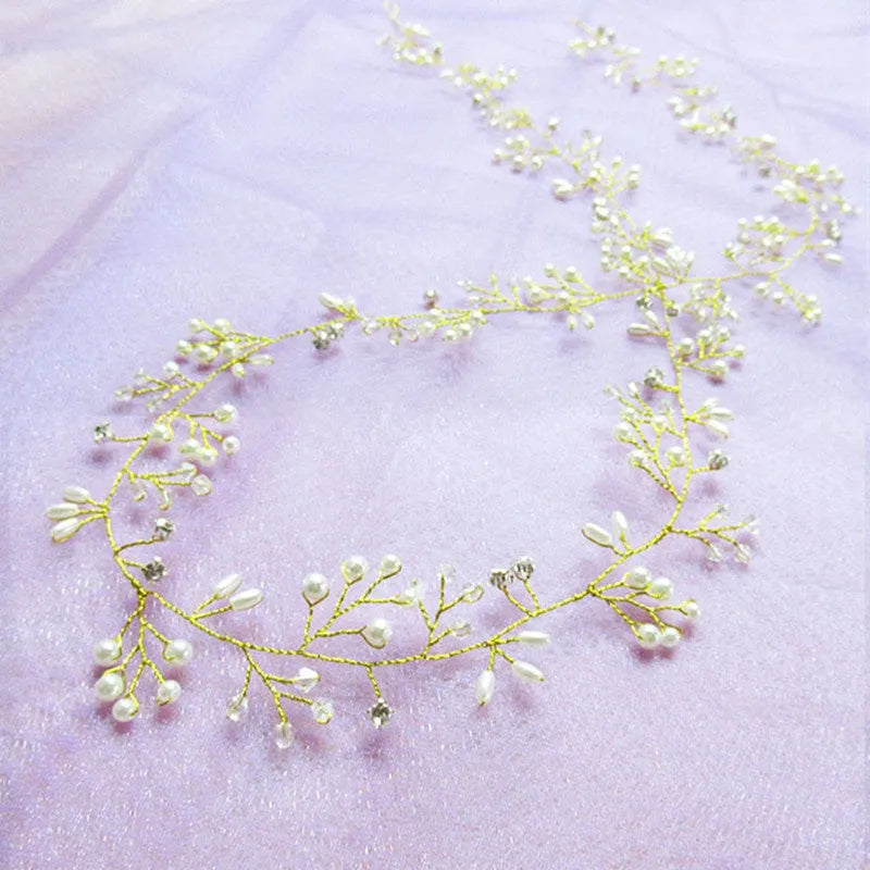 Long silver wire hair band with crystal and pearl decorations for bridal hairstyling.
