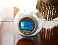 White colourful natural sound alarm clock with LCD display showing time and temperature