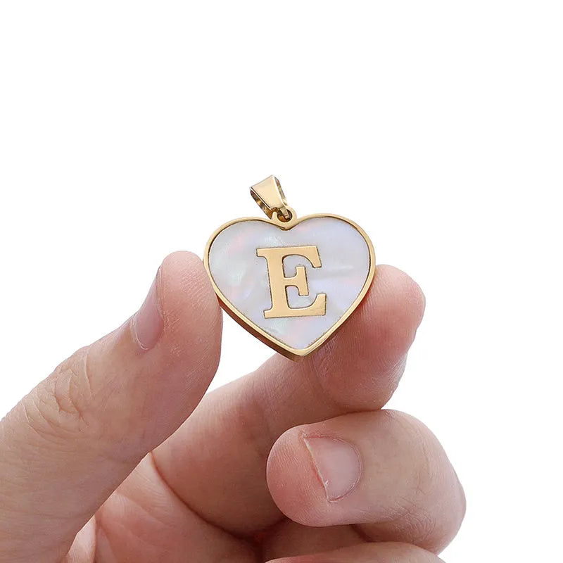 Gold plated chain necklace with a white shell heart-shaped pendant personalised with a single letter initial.