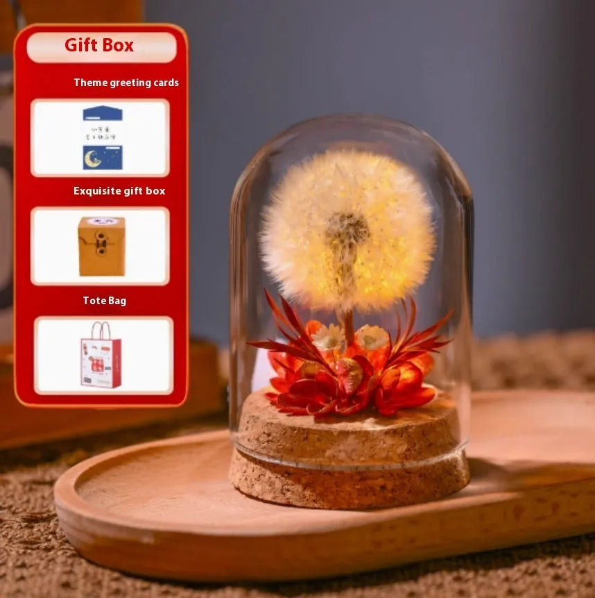 Dandelion-shaped glass night light ornament in gradient colours on wooden surface