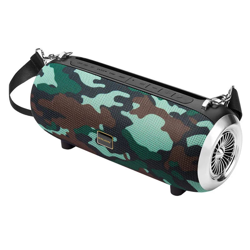 F666 portable fabric Bluetooth speaker with shoulder strap on a table next to a phone
