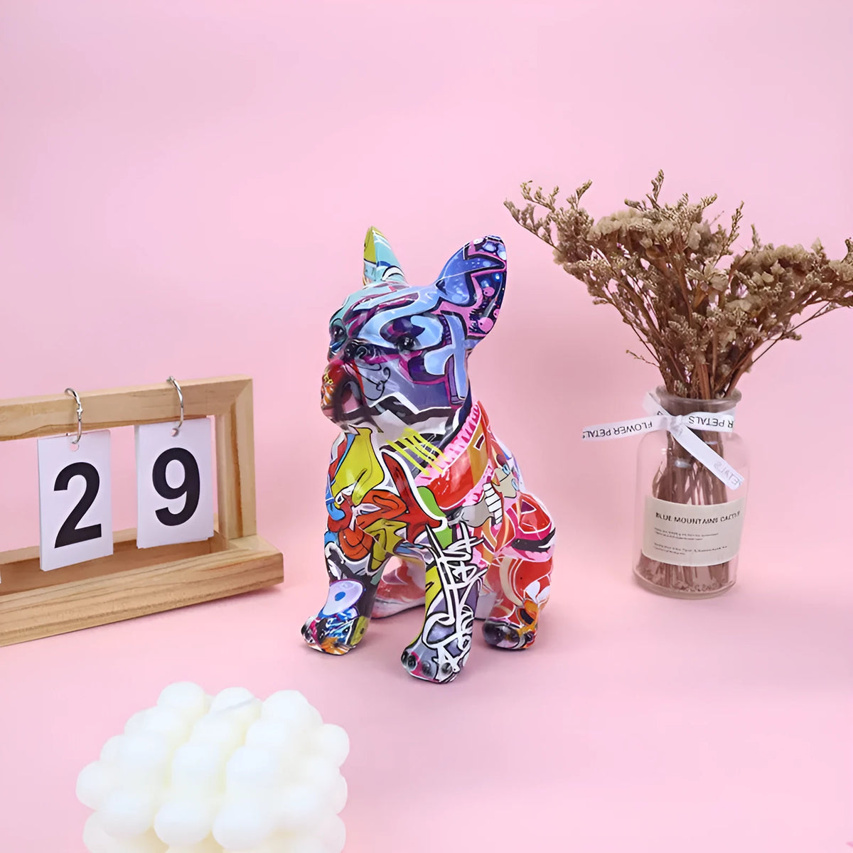Modern simple resin bulldog statue in graffiti colour on a shelf