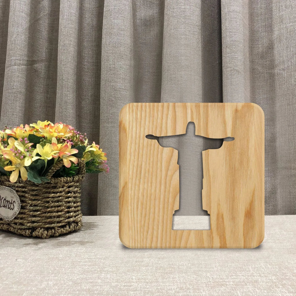 Solid wood hollow LED night lamp warm white with USB cable on wooden surface