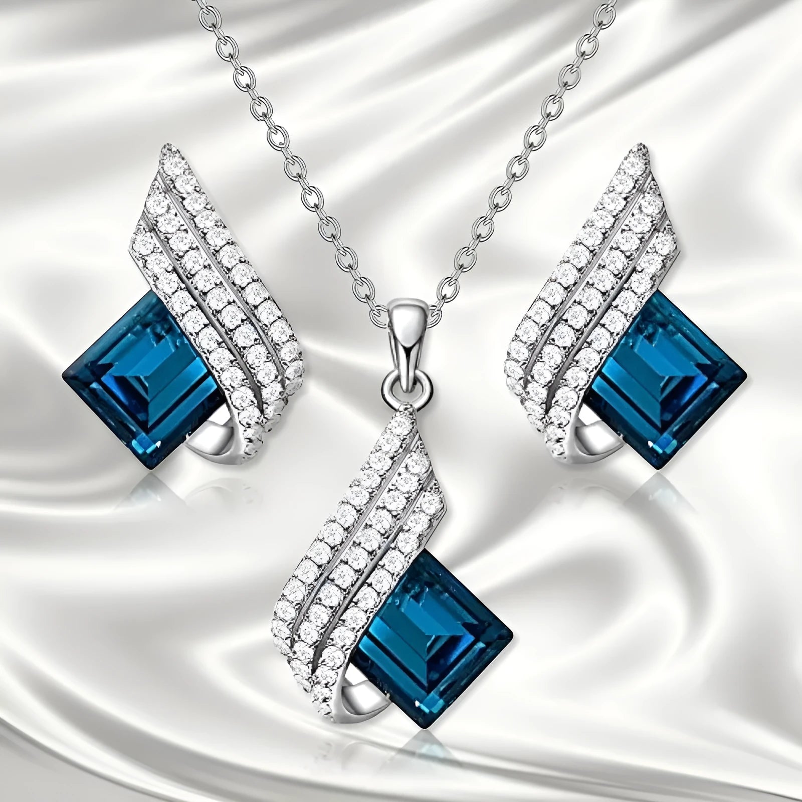 Alloy pendant necklace and matching earrings with glass ornamentation and cross chain design