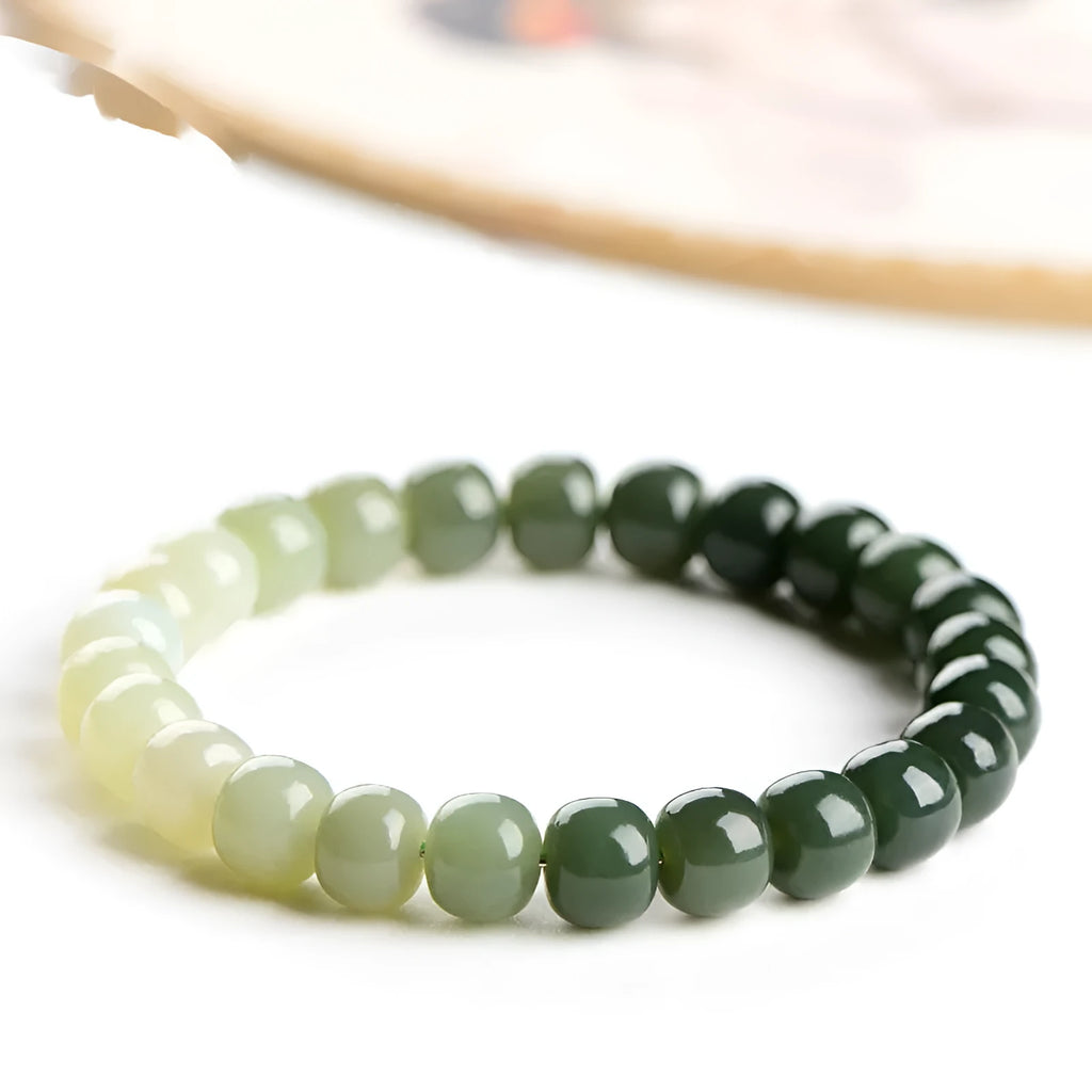 Polished Hetian Jade bracelet showing a gradient water colour on beads.
