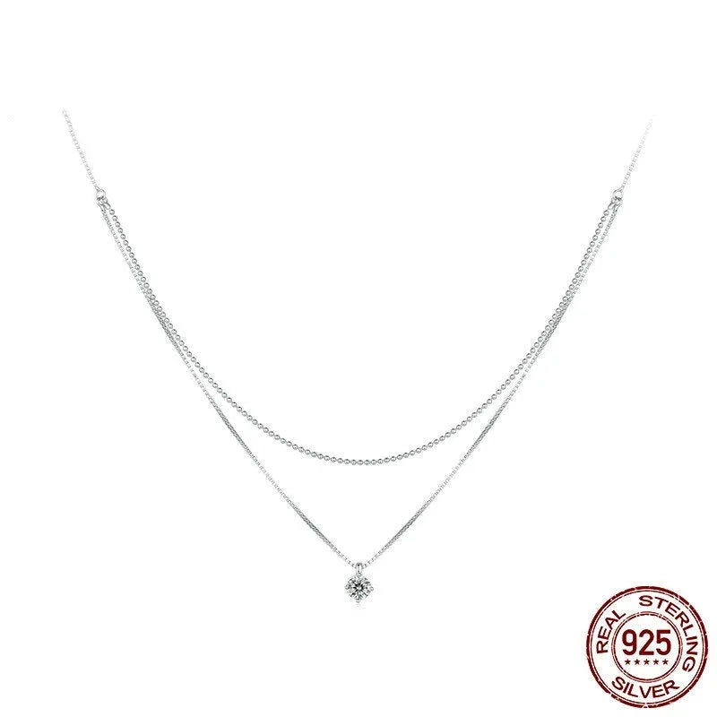 Close-up of a women's double-layer pearl chain sterling silver necklace with a matching pendant.