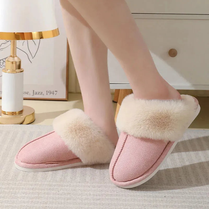 Women's plush winter slippers in grey with a round toe, flat heel, and non-slip PVC sole.