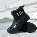 Short tube PVC waterproof boots in black, black and yellow, or khaki with flat heel and round toe.