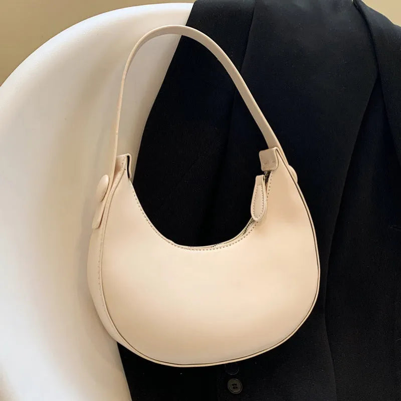 Retro dumpling-shaped women's shoulder bag in PU leather with a zippered pocket.