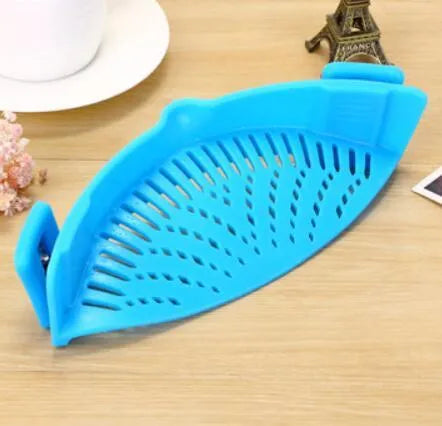 Silicone clip-on kitchen strainer with stainless steel filter mesh attached to a pot rim