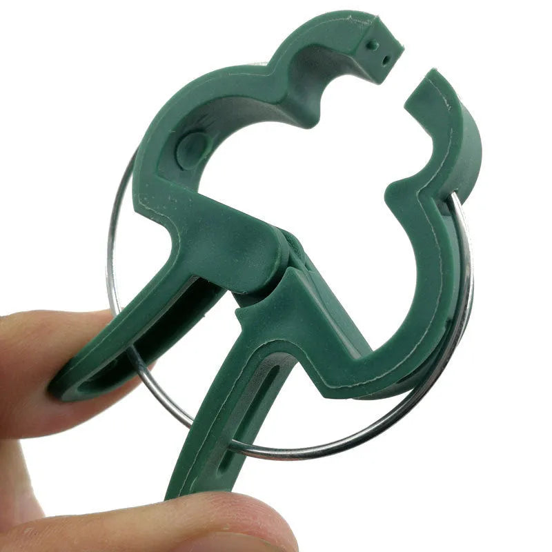 Green plastic and zinc plant fixing clips for supporting tomatoes, cucumbers, and climbing vines.
