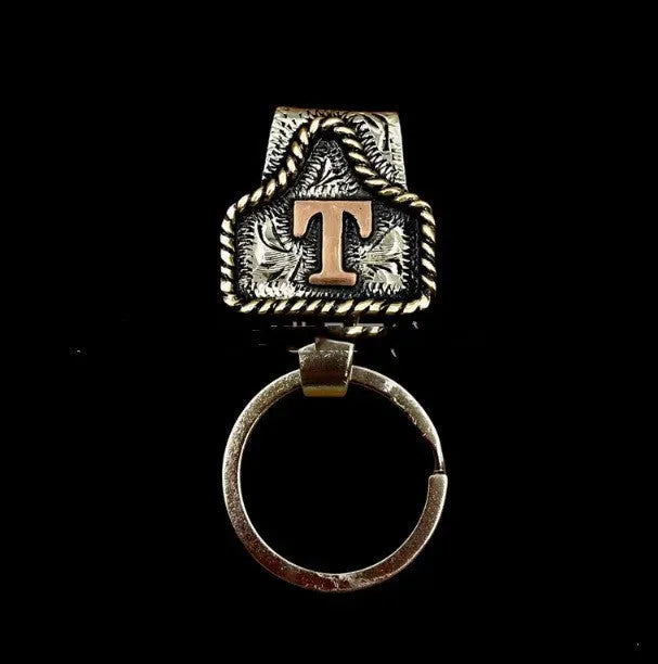 Handmade metal cow tag belt keychain in rustic design with multiple colour options