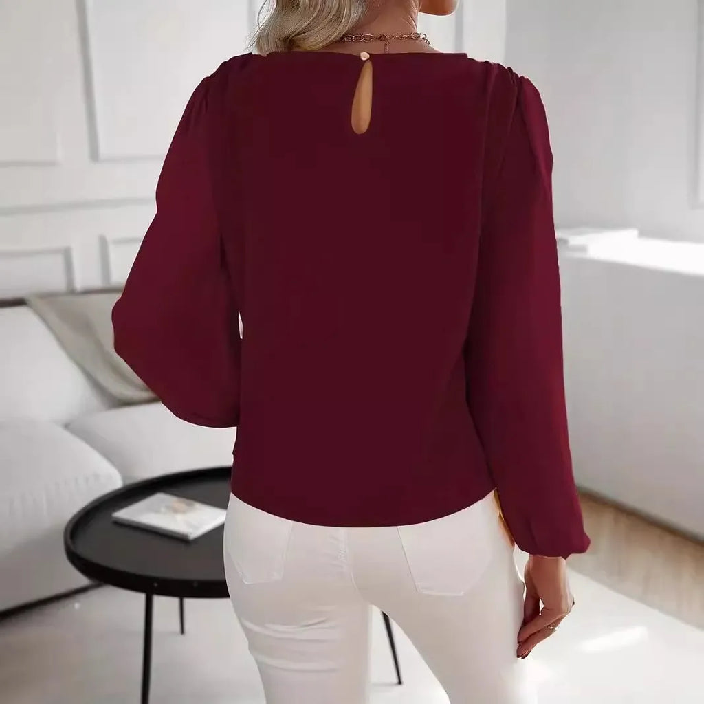 Wine red women's solid colour round neck long sleeve polyester top with button front, shown on a model.
