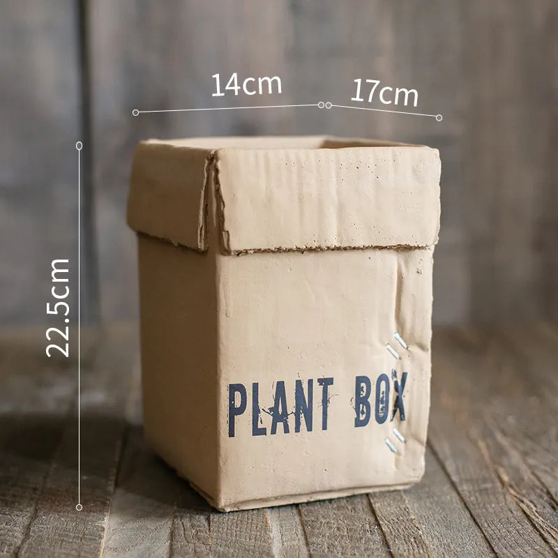 Cement flowerpot with paper carton aesthetic and drainage hole in Nordic style for indoor plants