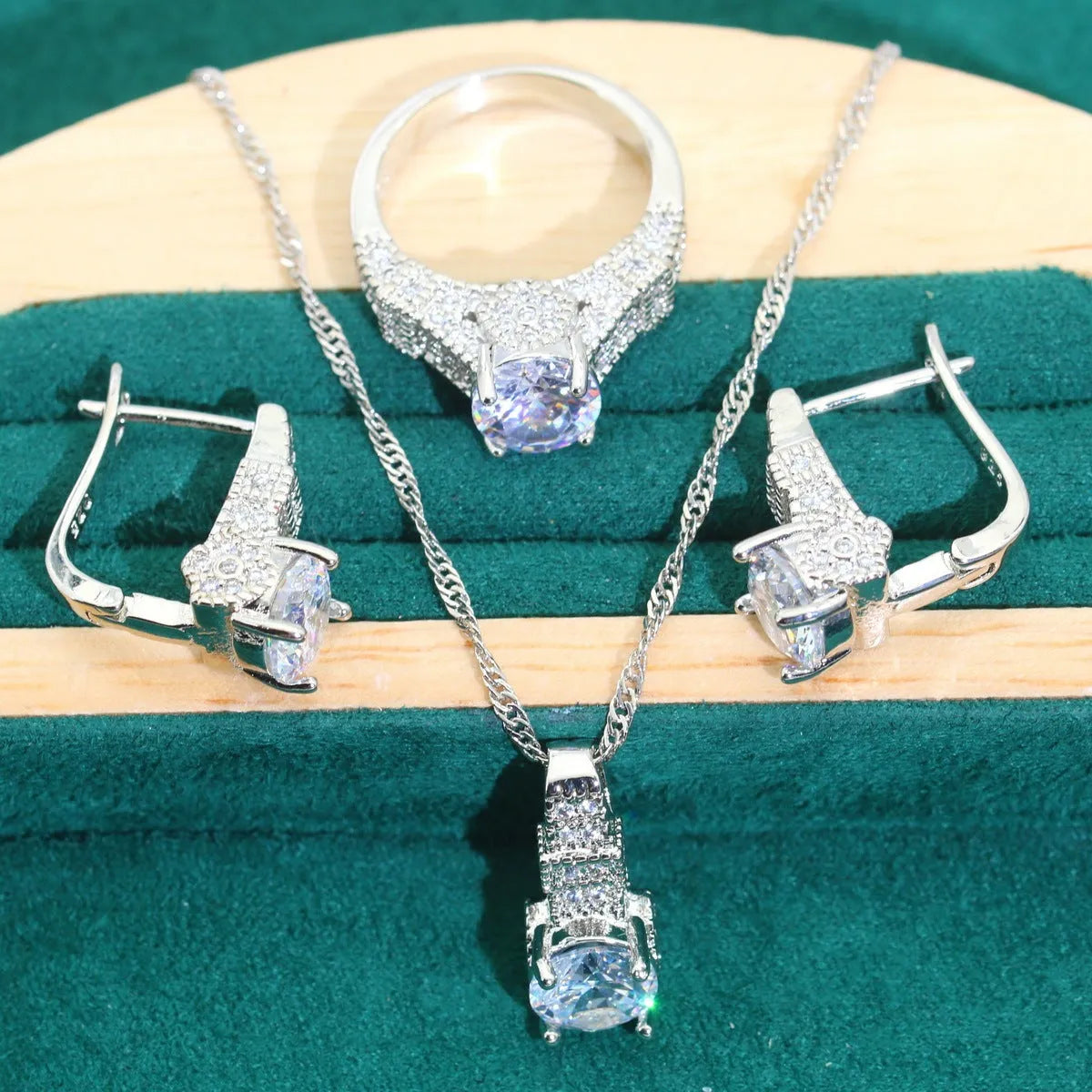 Bridal zircon four-piece jewellery set showing necklace, bracelet, earrings and ring in alloy with water wave chain