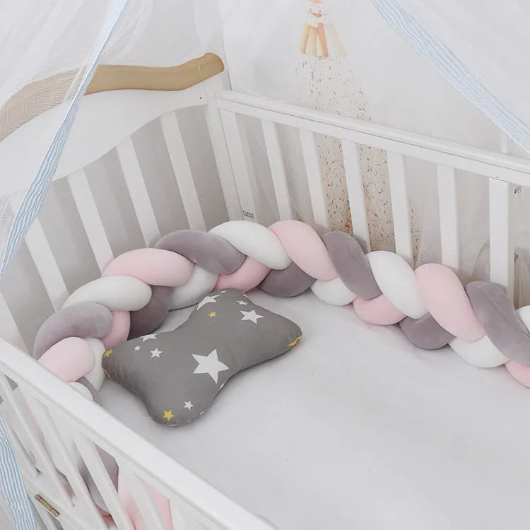 Braided knot style baby cot bumper in spandex crystal velvet fabric, shown in a light grey colour.
