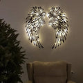 Carved metal angel wings wall decor in iron with double-sided black finish, available with or without light